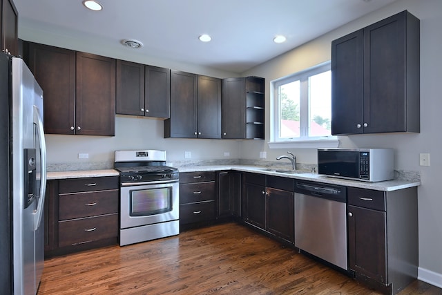 315 N Ridgeland Ave, Elmhurst, IL 60126 - kitchen with appliances with stainless steel finishes, dark wood-style flooring, dark brown cabinetry, recessed lighting, and light stone countertops