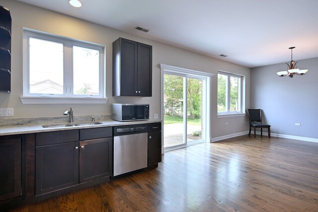 315 N Ridgeland Ave, Elmhurst, IL 60126 - kitchen featuring appliances with stainless steel finishes, dark wood-type flooring, a chandelier, light stone countertops, and decorative light fixtures
