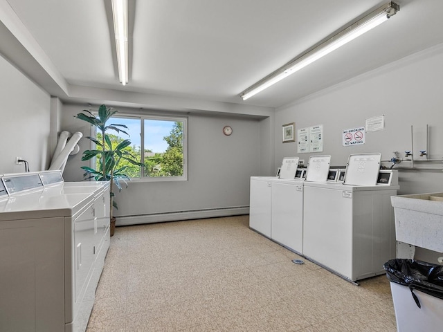 940 E Old Willow Rd Unit 305, Prospect Heights, IL 60070 - shared laundry room featuring washing machine and dryer, a baseboard radiator, and light flooring