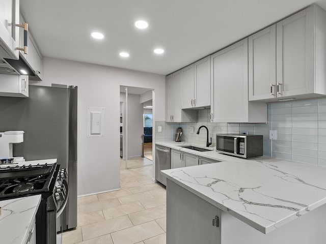 940 E Old Willow Rd Unit 305, Prospect Heights, IL 60070 - kitchen featuring appliances with stainless steel finishes, backsplash, light stone counters, recessed lighting, and a peninsula