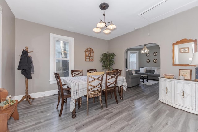 1404 Fell Ave, Bloomington, IL 61701 - dining space featuring attic access, plenty of natural light, light wood finished floors, and arched walkways