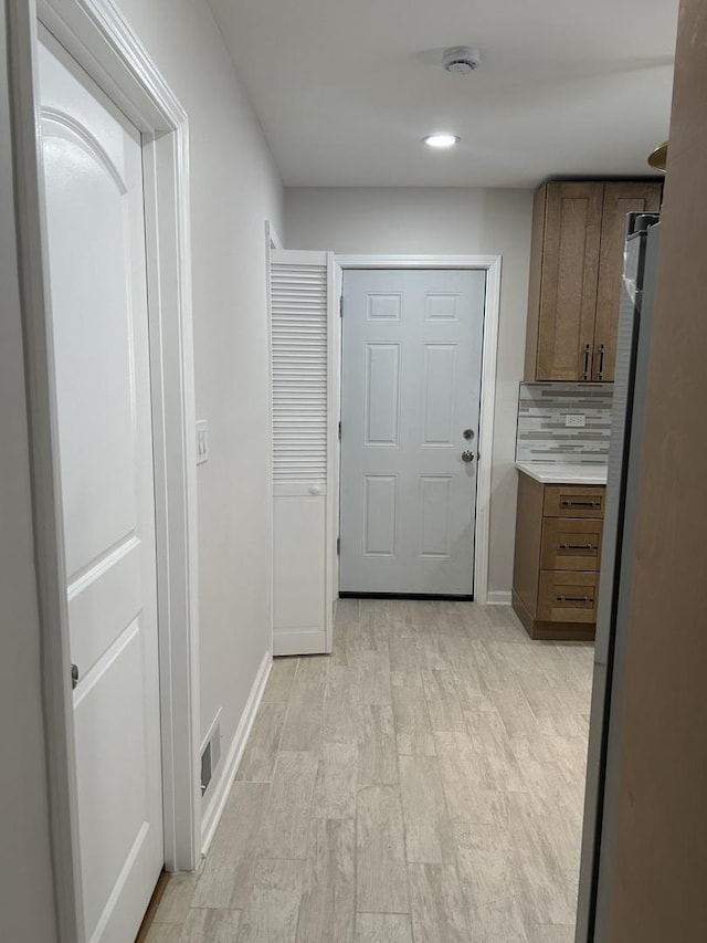 1122 N Mason Ave, Chicago, IL 60651 - doorway to outside featuring light wood finished floors and baseboards