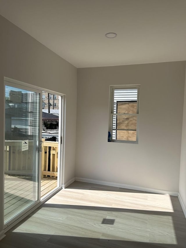 1122 N Mason Ave, Chicago, IL 60651 - spare room featuring baseboards and wood finished floors