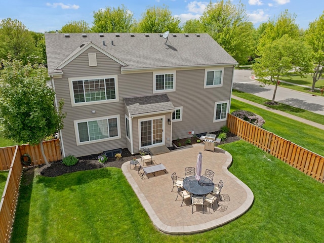 9312 Bristol Ln, Huntley, IL 60142 - back of property with a shingled roof, a patio area, and a fenced backyard