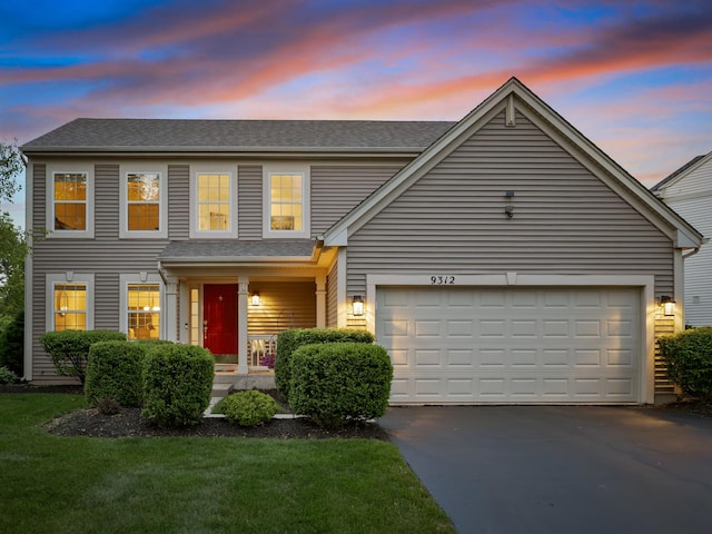 9312 Bristol Ln, Huntley, IL 60142 - view of front of house featuring concrete driveway, covered porch, a front yard, a garage, and a shingled roof
