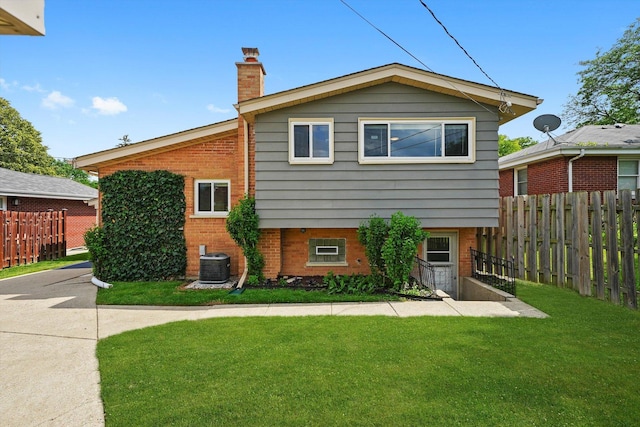 56 W Granville Ave, Roselle, IL 60172 - back of house featuring brick siding and a chimney