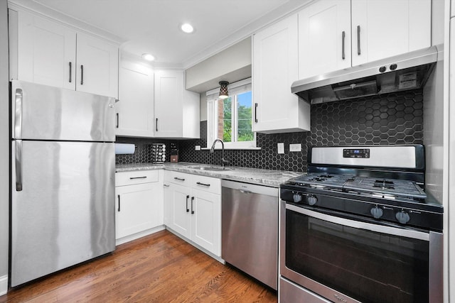 56 W Granville Ave, Roselle, IL 60172 - kitchen featuring stainless steel appliances, white cabinetry, light stone countertops, exhaust hood, and backsplash