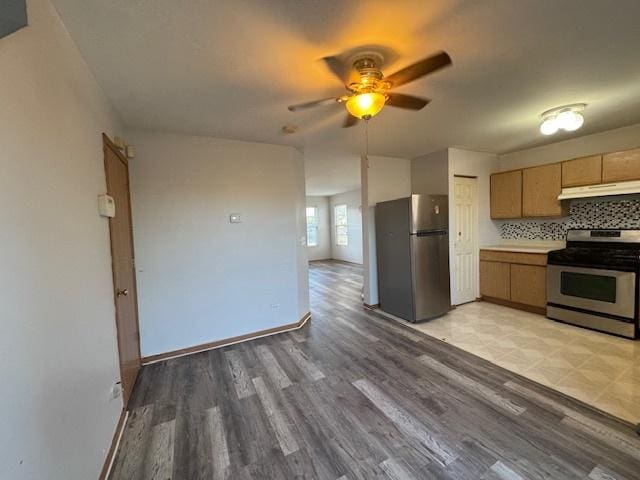 923 E Savannah Dr, Romeoville, IL 60446 - kitchen with stainless steel appliances, under cabinet range hood, ceiling fan, and light wood finished floors