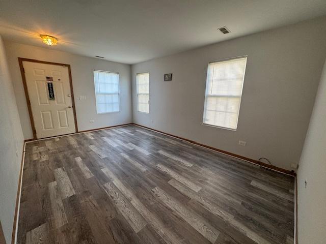 923 E Savannah Dr, Romeoville, IL 60446 - unfurnished living room with wood finished floors and baseboards