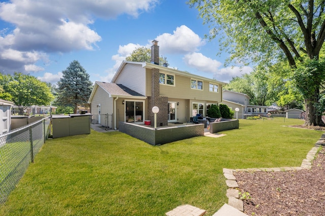 6S184 Lakewood Dr, Naperville, IL 60540 - back of property featuring a fenced backyard, a chimney, and a patio area