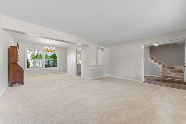 6S184 Lakewood Dr, Naperville, IL 60540 - unfurnished living room with stairs, a chandelier, and light carpet