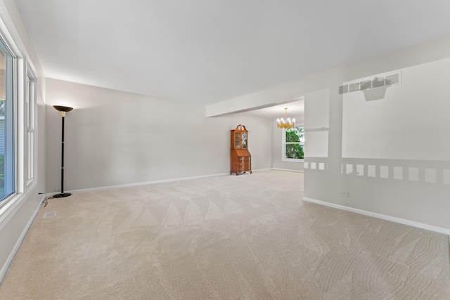 6S184 Lakewood Dr, Naperville, IL 60540 - spare room featuring carpet flooring and a chandelier