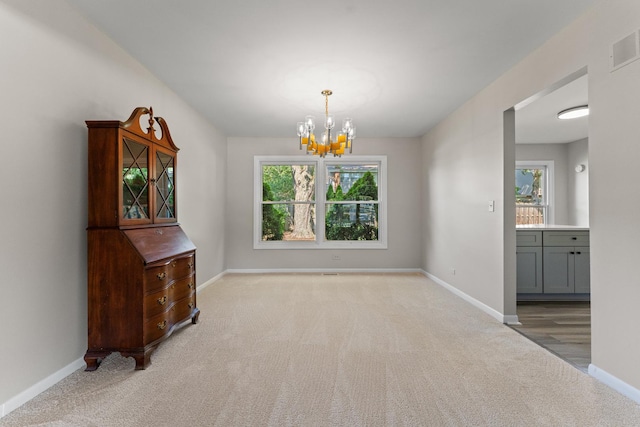 6S184 Lakewood Dr, Naperville, IL 60540 - unfurnished dining area with healthy amount of natural light, a chandelier, and carpet flooring