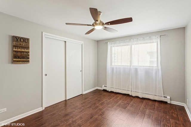 6839 N NW Hwy Unit 2B, Chicago, IL 60631 - unfurnished bedroom with dark wood finished floors, a closet, a baseboard radiator, ceiling fan, and baseboard heating