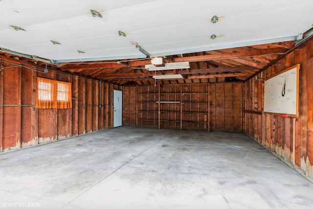 1036 Perda Ln, Des Plaines, IL 60016 - garage featuring wooden walls and a garage door opener