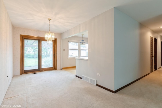 1036 Perda Ln, Des Plaines, IL 60016 - unfurnished room with a chandelier and light colored carpet