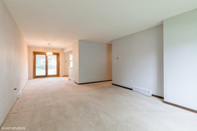 1036 Perda Ln, Des Plaines, IL 60016 - spare room with light carpet and a chandelier