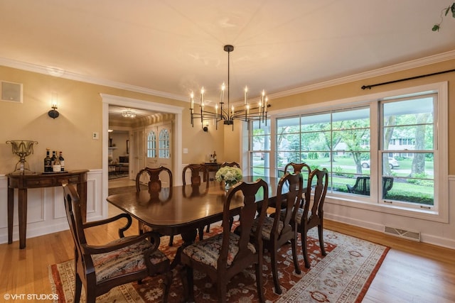 1076 Old Barn Ln, Lake Forest, IL 60045 - dining room with light wood finished floors, a chandelier, crown molding, and wainscoting