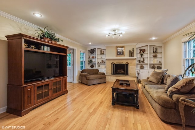 1076 Old Barn Ln, Lake Forest, IL 60045 - living area featuring light wood-style floors, ornamental molding, a fireplace with raised hearth, a chandelier, and recessed lighting