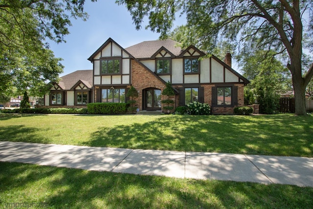 1148 N Anvil Ct, Addison, IL 60101 - tudor house featuring a chimney, stucco siding, and brick siding