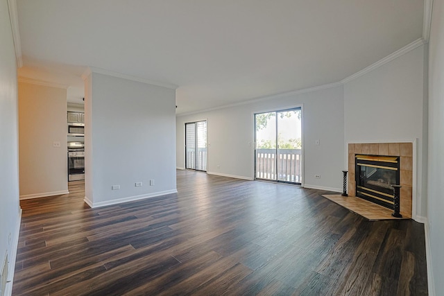 2354 S St Unit E, Elgin, IL 60123 - unfurnished living room featuring ornamental molding, dark wood-type flooring, and a tiled fireplace