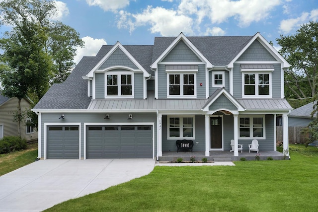 1947 Summerton Pl, Northbrook, IL 60062 - view of front facade with driveway, a front yard, a porch, a standing seam roof, and roof with shingles
