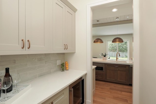 1947 Summerton Pl, Northbrook, IL 60062 - bar area featuring beverage cooler, wood finished floors, decorative backsplash, hanging light fixtures, and recessed lighting