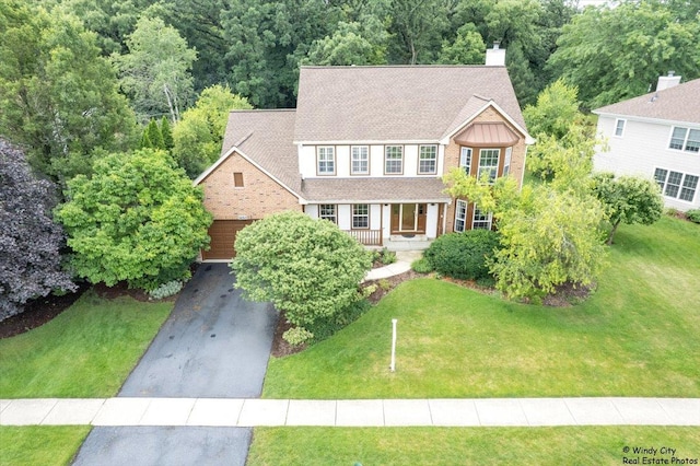 36917 N Deer Trail Dr, Lake Villa, IL 60046 - colonial-style house with a chimney, a front lawn, driveway, and covered porch
