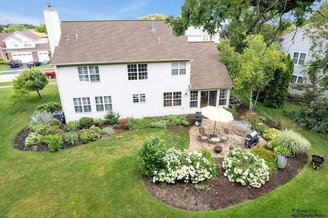 36917 N Deer Trail Dr, Lake Villa, IL 60046 - rear view of property featuring a lawn, a patio area, a chimney, and a shingled roof