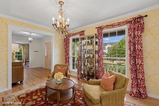36917 N Deer Trail Dr, Lake Villa, IL 60046 - sitting room featuring a chandelier, wood finished floors, wallpapered walls, and ornamental molding