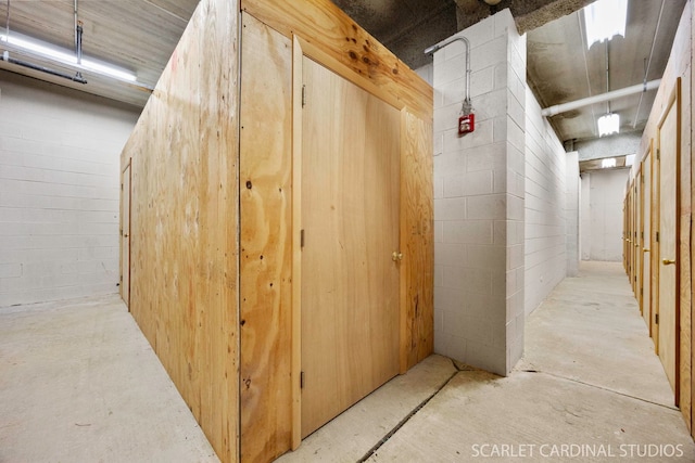 1500 S Ardmore Ave Unit 612, Villa Park, IL 60181 - hall with unfinished concrete flooring and concrete block wall