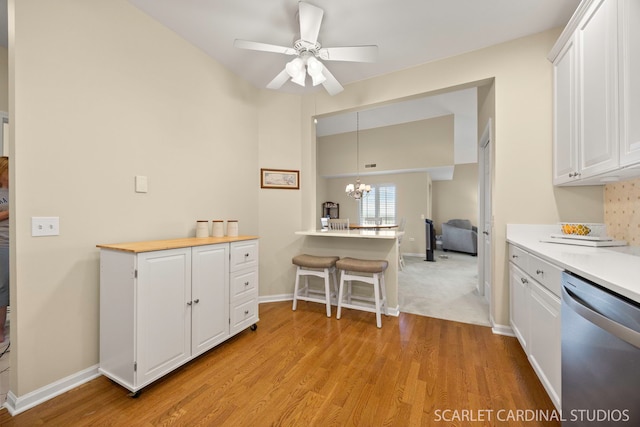 1500 S Ardmore Ave Unit 612, Villa Park, IL 60181 - kitchen featuring stainless steel dishwasher, white cabinets, a chandelier, light wood-type flooring, and vaulted ceiling