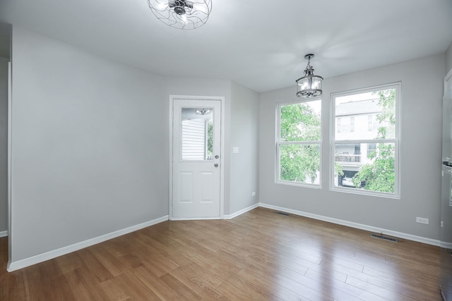 635 Conservatory Ln Unit 635, Aurora, IL 60502 - unfurnished dining area featuring wood finished floors and a chandelier