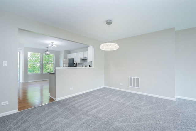 635 Conservatory Ln Unit 635, Aurora, IL 60502 - carpeted empty room featuring a chandelier