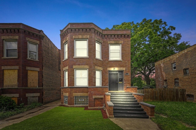 7548 S Harvard Ave, Chicago, IL 60620 - view of front of house featuring brick siding and a front yard