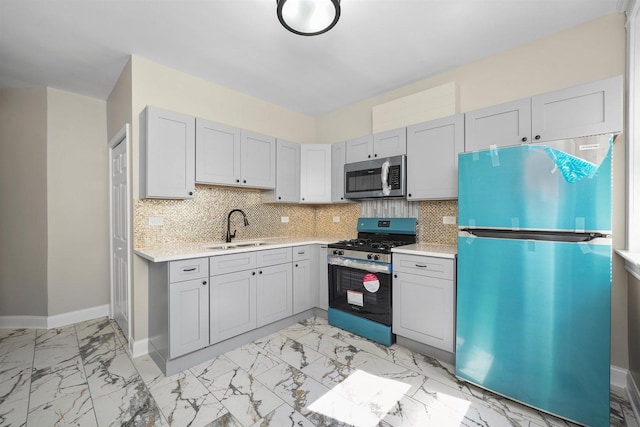 7548 S Harvard Ave, Chicago, IL 60620 - kitchen featuring appliances with stainless steel finishes, light marble finish flooring, light countertops, backsplash, and gray cabinets