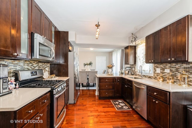8036 S Fawn Trl, Justice, IL 60458 - kitchen featuring appliances with stainless steel finishes, dark wood finished floors, decorative backsplash, and dark brown cabinetry
