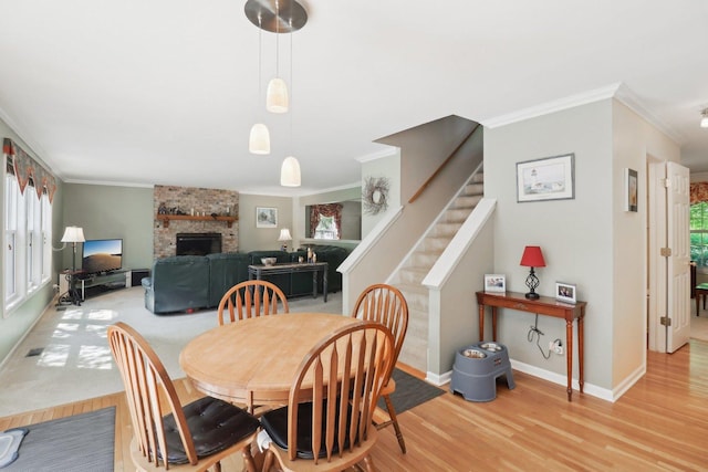 305 Buckingham Dr, Algonquin, IL 60102 - dining space with ornamental molding, light wood finished floors, a fireplace, and stairs