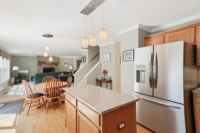 305 Buckingham Dr, Algonquin, IL 60102 - kitchen with stainless steel fridge with ice dispenser, crown molding, light wood-type flooring, a brick fireplace, and decorative light fixtures