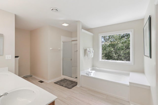305 Buckingham Dr, Algonquin, IL 60102 - full bath featuring a shower stall, a garden tub, double vanity, and wood finished floors