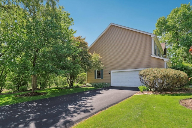 305 Buckingham Dr, Algonquin, IL 60102 - view of side of home with driveway, a garage, and a lawn
