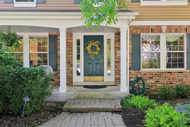 305 Buckingham Dr, Algonquin, IL 60102 - doorway to property with brick siding and covered porch