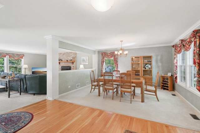 305 Buckingham Dr, Algonquin, IL 60102 - dining room with ornamental molding, wood finished floors, a chandelier, and a stone fireplace