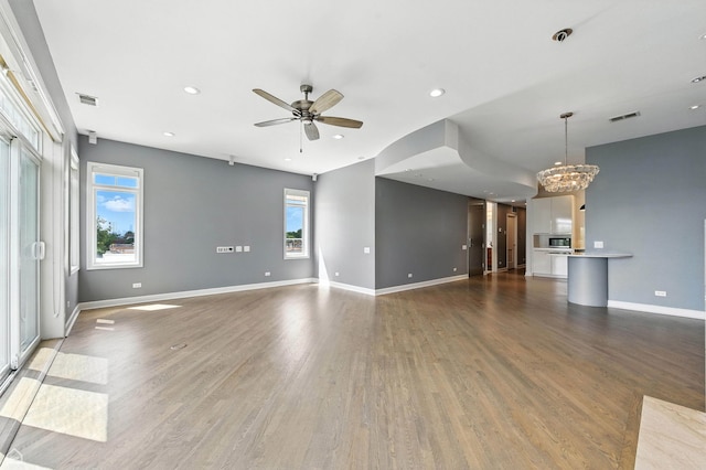 4736 N Lincoln Ave Unit 4, Chicago, IL 60625 - unfurnished living room with a chandelier, ceiling fan, wood finished floors, and recessed lighting