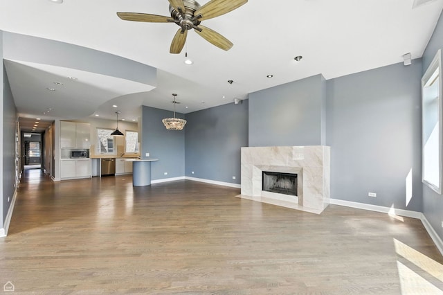 4736 N Lincoln Ave Unit 4, Chicago, IL 60625 - unfurnished living room with a premium fireplace, wood finished floors, a chandelier, ceiling fan, and recessed lighting
