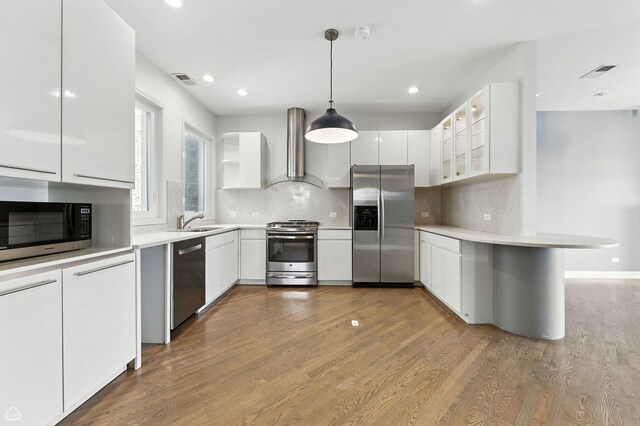 4736 N Lincoln Ave Unit 4, Chicago, IL 60625 - kitchen with stainless steel appliances, wall chimney exhaust hood, white cabinetry, wood finished floors, and recessed lighting