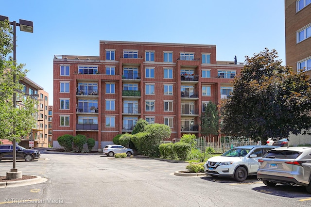 1670 Mill St Unit 508, Des Plaines, IL 60016 - view of apartment building / complex featuring uncovered parking
