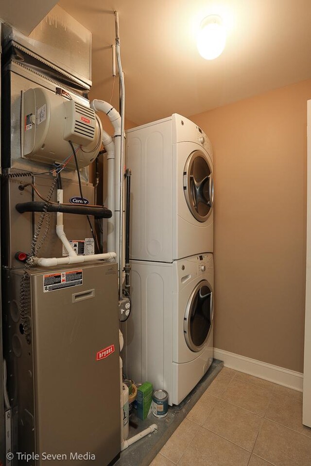 1670 Mill St Unit 508, Des Plaines, IL 60016 - washroom with stacked washer and clothes dryer and light tile patterned flooring