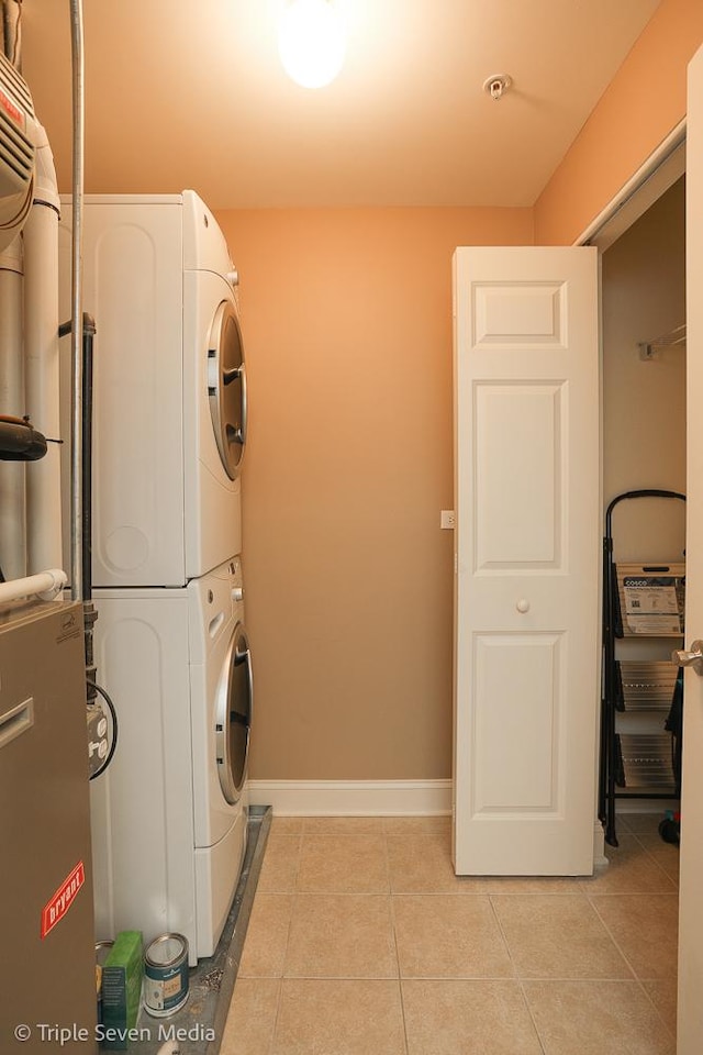 1670 Mill St Unit 508, Des Plaines, IL 60016 - laundry area with stacked washer / dryer and light tile patterned floors