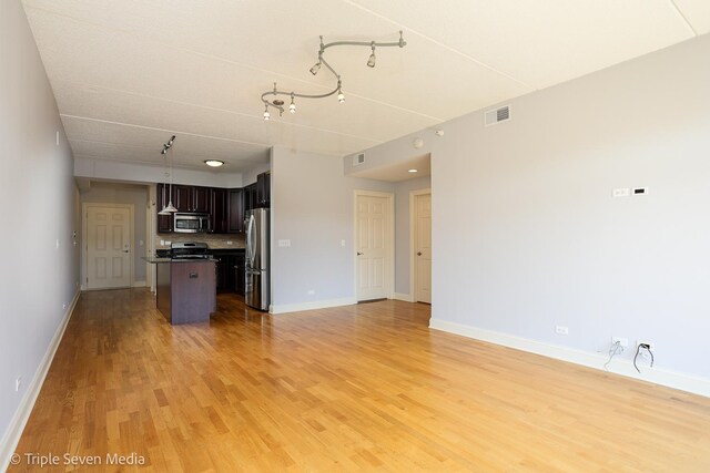 1670 Mill St Unit 508, Des Plaines, IL 60016 - unfurnished living room with light wood-style flooring and track lighting